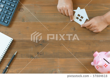 hands holding house paper with calculator hands holding house paper with calculator 37884618