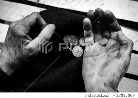 The beggar considers coins. Black and white The beggar considers coins. Black and white 37885067