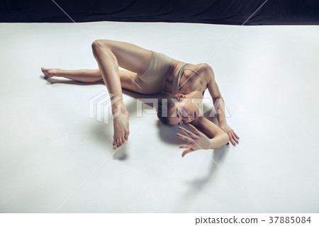Young teen dancer ion white floor background. Young teen dancer ion white floor background. 37885084