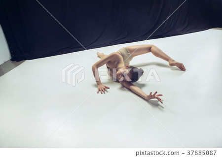 Young teen dancer ion white floor background. Young teen dancer ion white floor background. 37885087