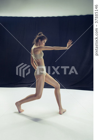 Young teen dancer ion white floor background. 37885146