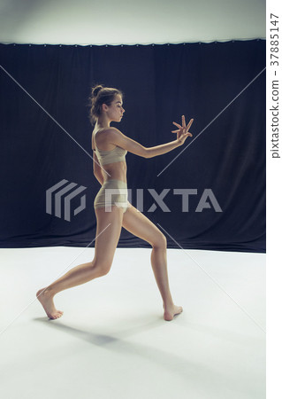 Young teen dancer ion white floor background. 37885147