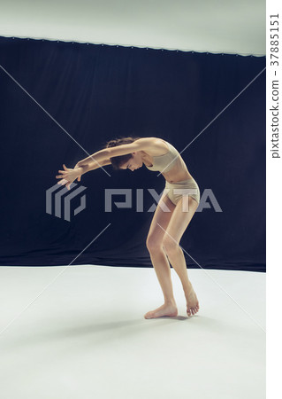 Young teen dancer ion white floor background. 37885151