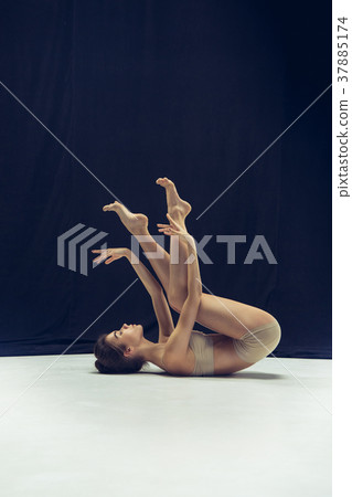 Young teen dancer ion white floor background. 37885174