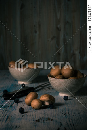 Brown edible mushrooms spilled Brown edible mushrooms spilled 37885343