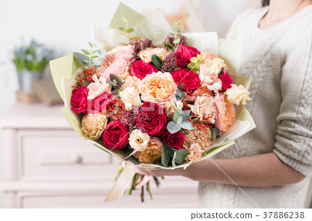 beautiful luxury bouquet of mixed flowers in woman 37886238