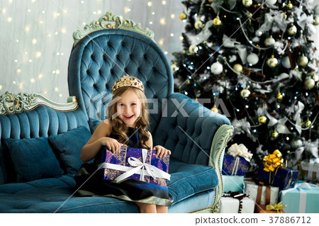 little girl holding a lot of boxes with gifts. little girl holding a lot of boxes with gifts. 37886712