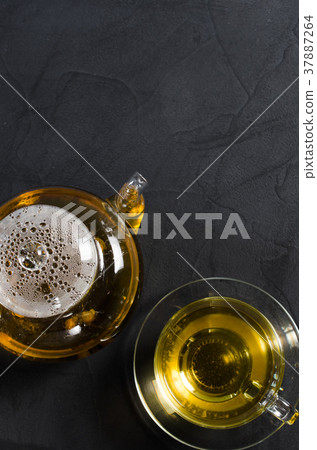 Cup of delicious herbal tea and glass teapot. 37887264
