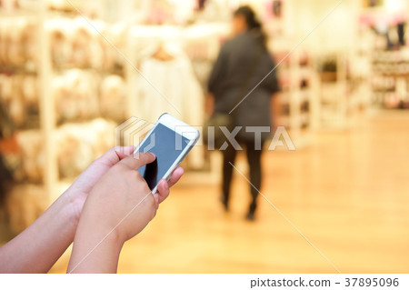 blurred image people walking in shopping centre. blurred image people walking in shopping centre. 37895096