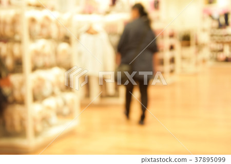 blurred image people walking in shopping centre. 37895099