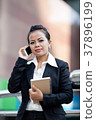 Business woman using mobile phone. 37896199