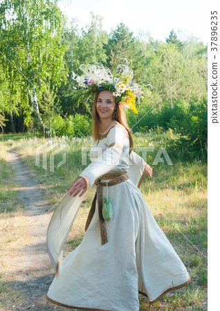 Beautiful woman with flower wreath 37896235