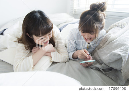 Girls relaxing in bed Girls relaxing in bed 37896408