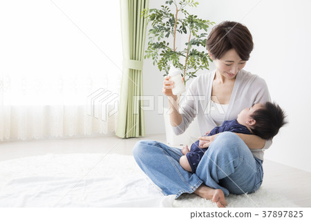 Woman holding a baby Woman holding a baby 37897825