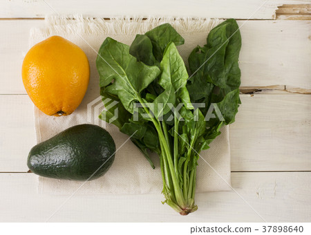 Bunch of fresh spinach, orange and avocado  37898640