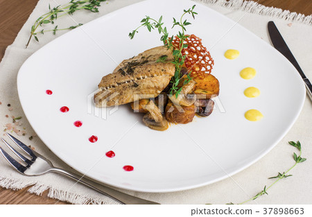 Baked fish with potatoes and mushrooms Baked fish with potatoes and mushrooms 37898663