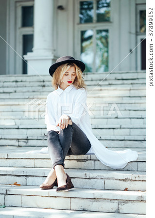 Girl is posing on the stone steps Girl is posing on the stone steps 37899152