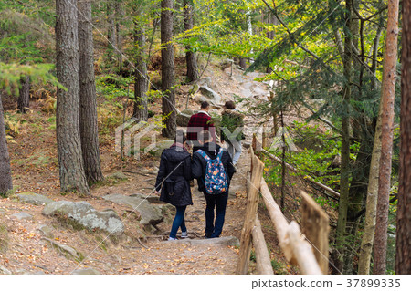 man and woman walking along hiking trail 37899335