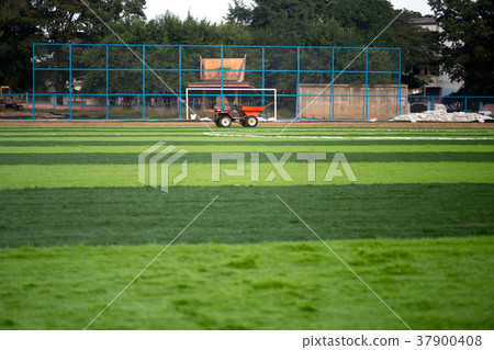 Orange truck with Artificial green grass 37900408