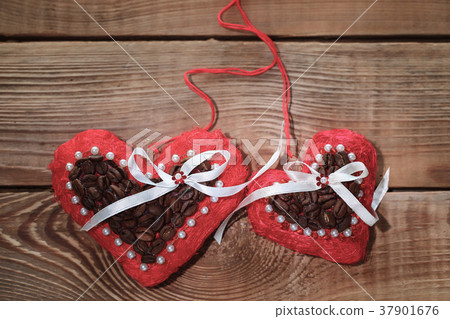 two felt red decorative heart on a wooden table two felt red decorative heart on a wooden table 37901676