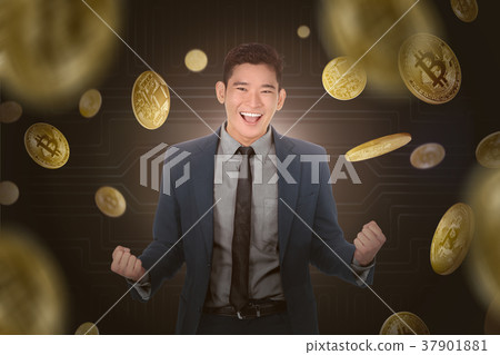 Happy asian businessman standing under a bitcoin rain 37901881