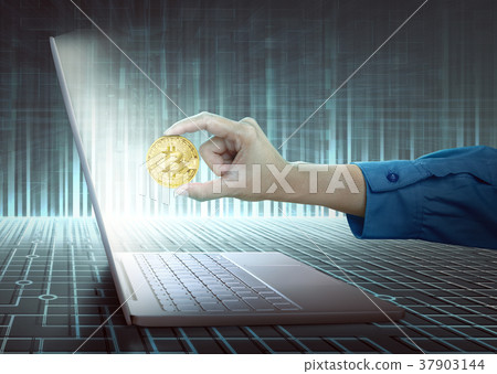 Women hand with laptop holding golden bitcoin 37903144