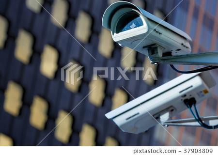 CCTV camwith blury business building on background CCTV camwith blury business building on background 37903809