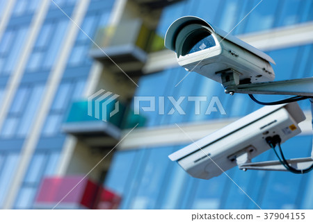 CCTV camera with blury business building 37904155