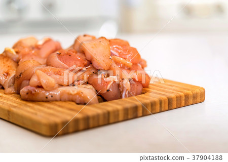Raw chicken fillet with spices on wooden board Raw chicken fillet with spices on wooden board 37904188