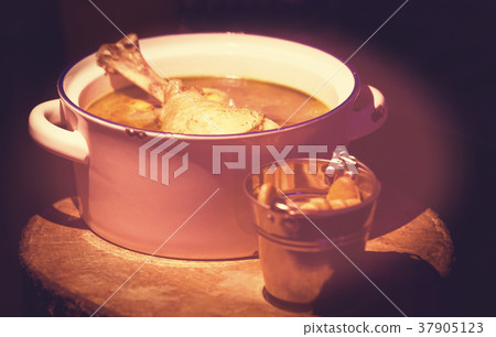Chicken broth with a piece of chicken in a saucepa Chicken broth with a piece of chicken in a saucepa 37905123