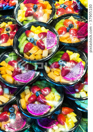 Salad sliced from fresh fruit in a plastic cup 37905180