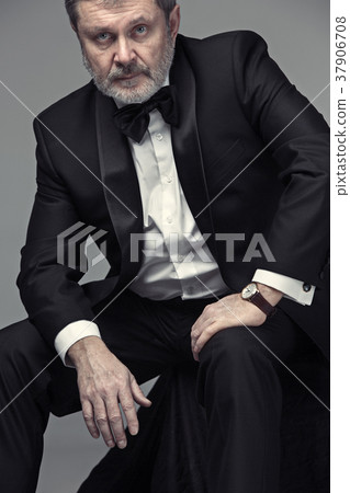 Senior Businessman sitting in chair Senior Businessman sitting in chair 37906708