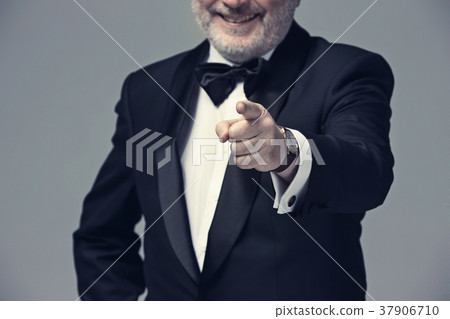 Senior Businessman standing and pointing to camera Senior Businessman standing and pointing to camera 37906710