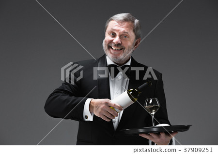 professional waiter in uniform is serving wine 37909251