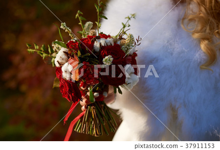 Beautiful bride holds wedding bouquet Beautiful bride holds wedding bouquet 37911153