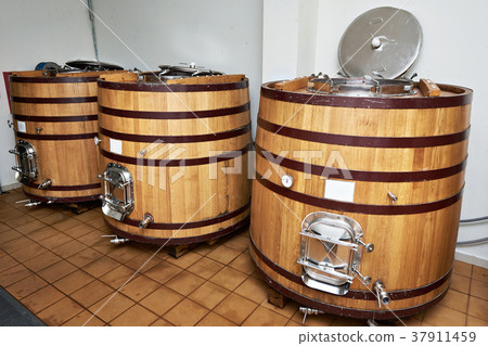 Wooden tank barrels for aging wine at winery 37911459