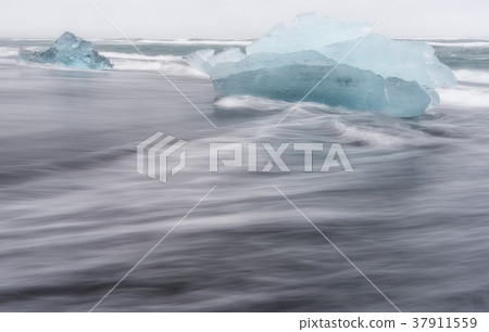 Melting ice floating in Jokulsarlon beach, Iceland Melting ice floating in Jokulsarlon beach, Iceland 37911559