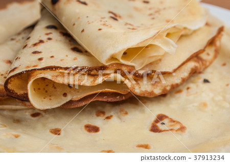 pancakes in a plate on wooden cutting board 37913234
