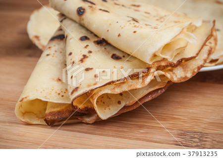 pancakes in a plate on wooden cutting board 37913235