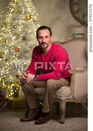 Handsome man in arm chair Handsome man in arm chair 37913376