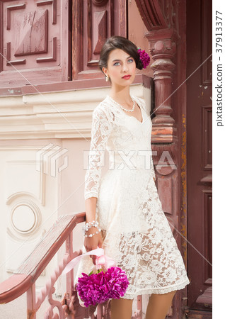 Young beautiful woman with flowers 37913377