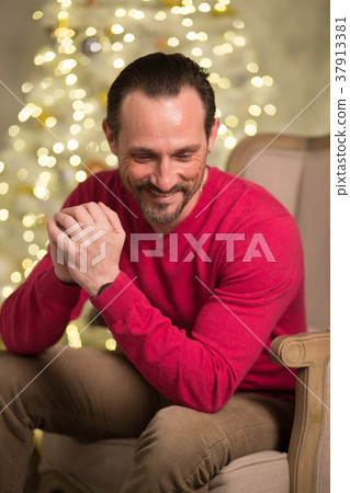Handsome man in arm chair Handsome man in arm chair 37913381