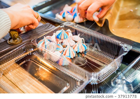 Colorful meringue kisses in plastic container Colorful meringue kisses in plastic container 37913778