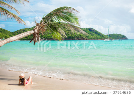 Young slim woman in bikini and straw hat lying on Young slim woman in bikini and straw hat lying on 37914686