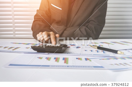 55 years old female businesswoman calculating cost 55 years old female businesswoman calculating cost 37924812