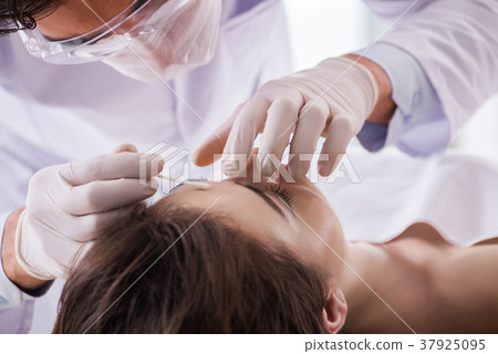 Police coroner examining dead body corpse in 37925095