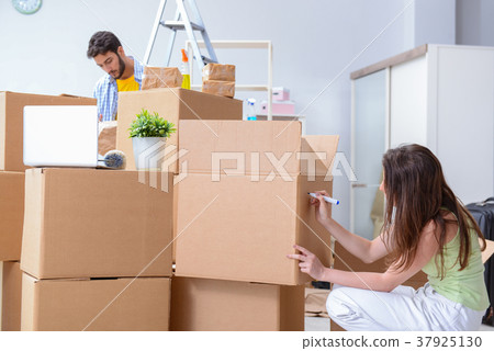Young family unpacking at new house with boxes Young family unpacking at new house with boxes 37925130