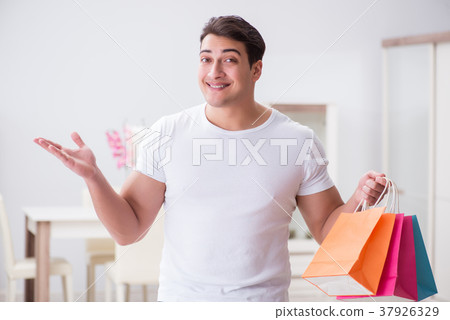 Young man with gift bag at home preparing suprise Young man with gift bag at home preparing suprise 37926329
