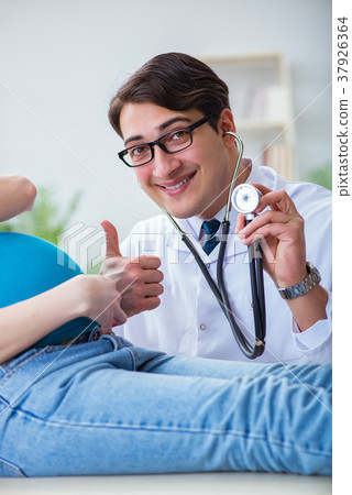 Doctor examining pregnant female patient in 37926364