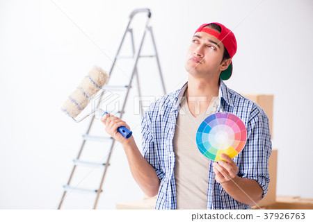 Young painter contractor choosing colors for home Young painter contractor choosing colors for home 37926763